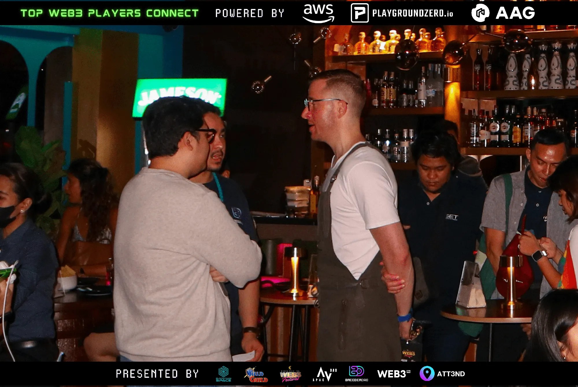 Two guests standing and talking among attendees at Top Web3 Players Connect