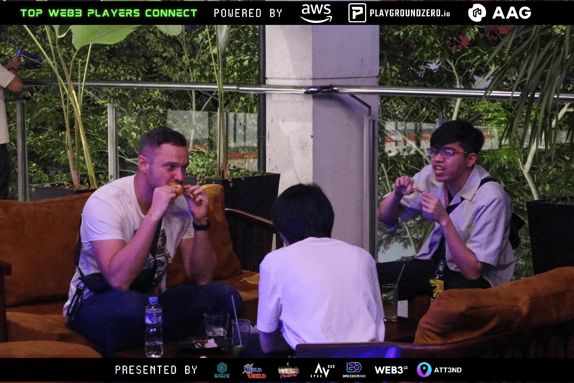 Three guests seated at a table talking at Top Web3 Players Connect