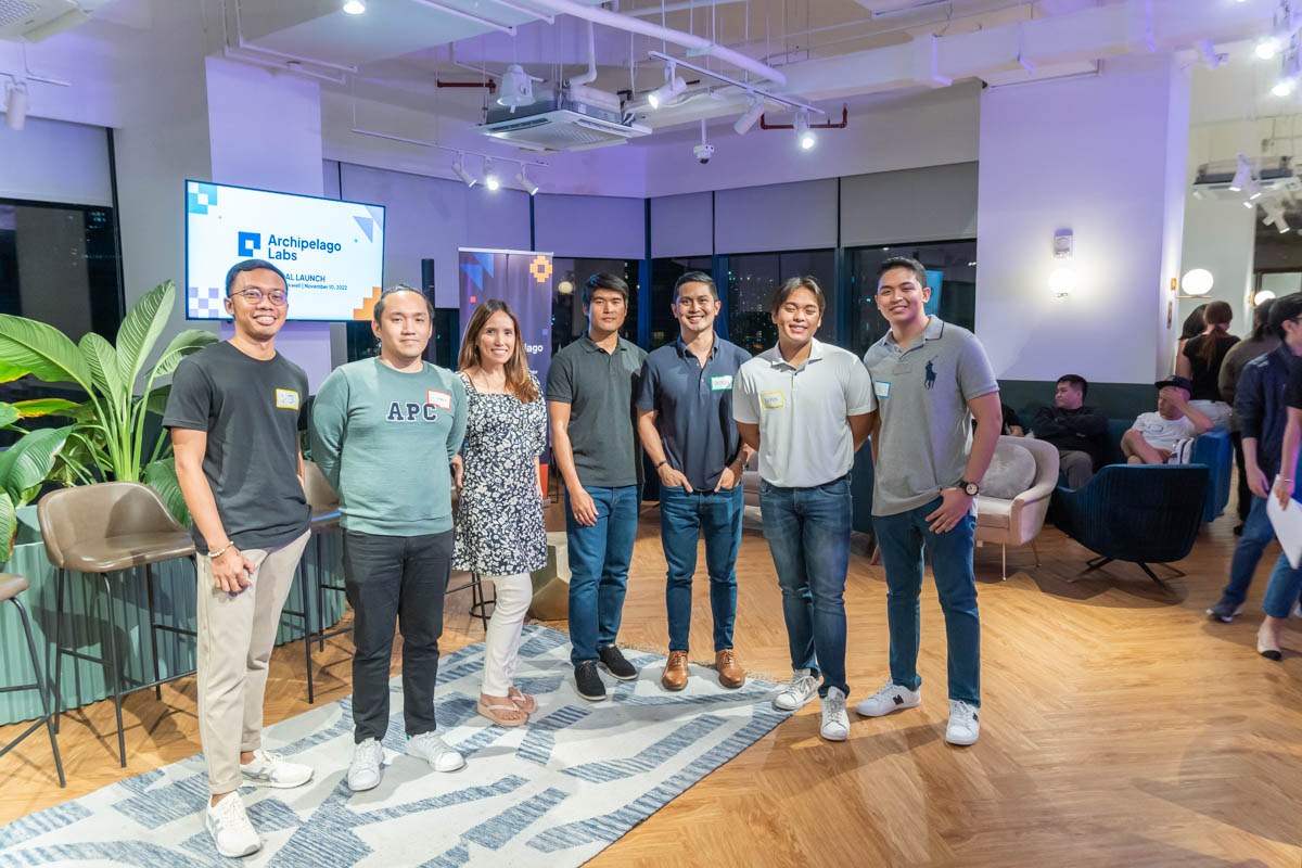 A group posing inside Common Ground at the Archipelago Labs launch