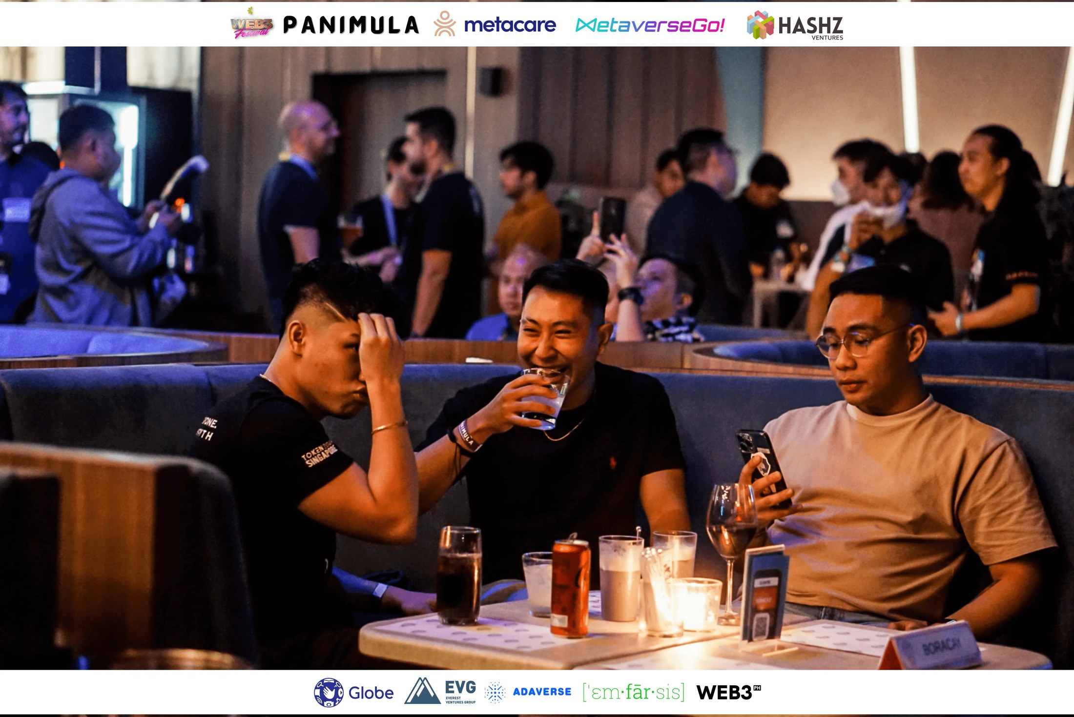 Attendees seated together at a table, listening during the Panimula program