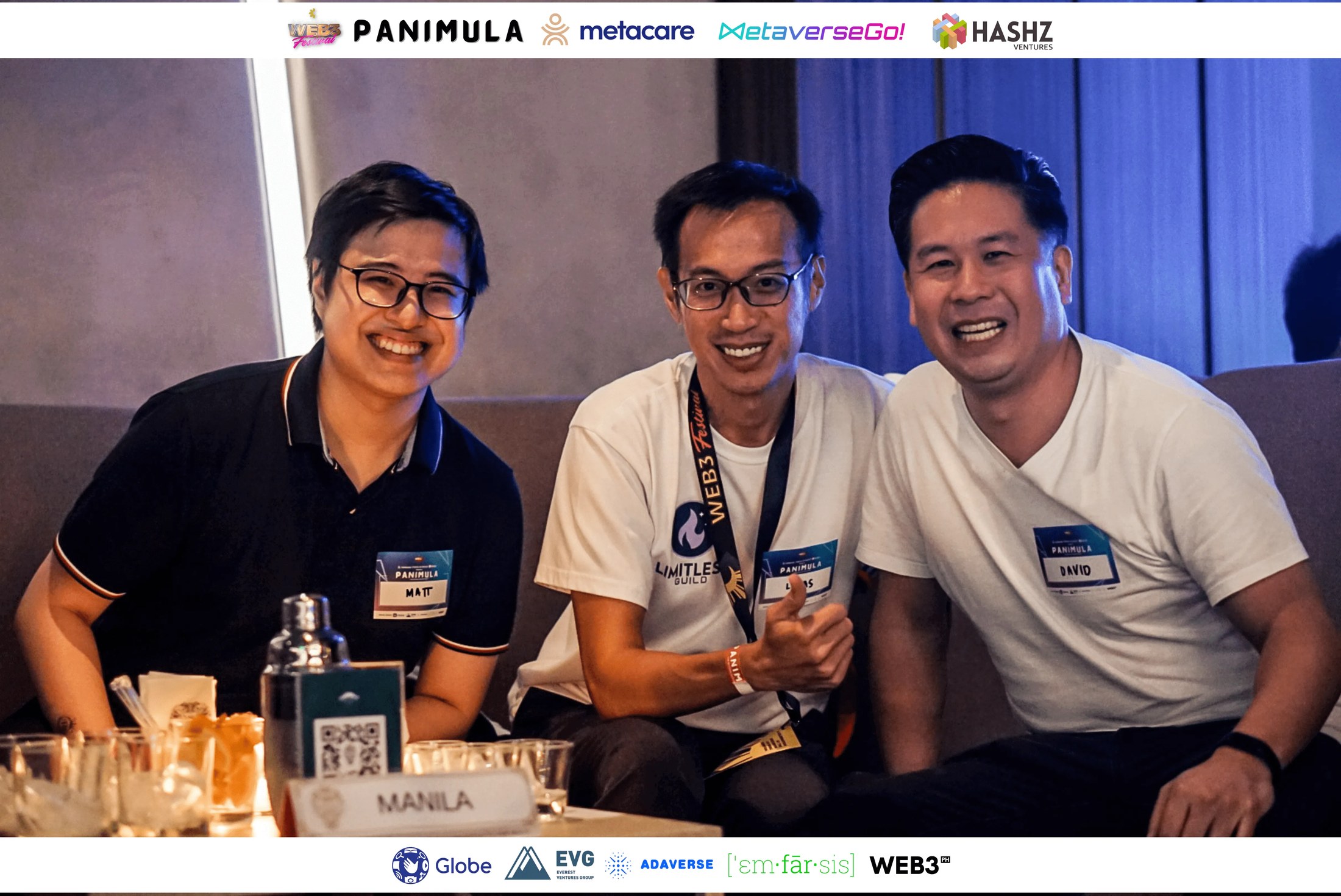 Three guests smiling together at a table during Panimula